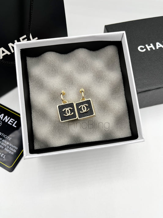 Black branded earrings chnl